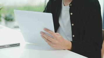 Financial analysts analyze business financial reports on a digital tablet planning investment project during a discussion at a meeting of corporate showing the results of their successful teamwork. video