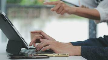 Financial analysts analyze business financial reports on a digital tablet planning investment project during a discussion at a meeting of corporate showing the results of their successful teamwork. video