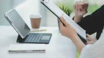 Financial analysts analyze business financial reports on a digital tablet planning investment project during a discussion at a meeting of corporate showing the results of their successful teamwork. video