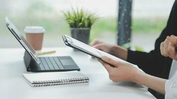 Financial analysts analyze business financial reports on a digital tablet planning investment project during a discussion at a meeting of corporate showing the results of their successful teamwork. video