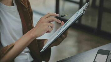 Financial analysts analyze business financial reports on a digital tablet planning investment project during a discussion at a meeting of corporate showing the results of their successful teamwork. video