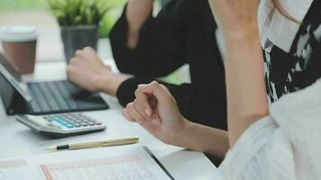 Financial analysts analyze business financial reports on a digital tablet planning investment project during a discussion at a meeting of corporate showing the results of their successful teamwork. video