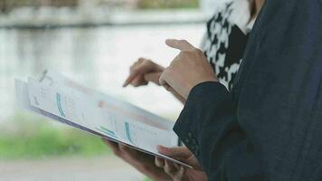 Financial analysts analyze business financial reports on a digital tablet planning investment project during a discussion at a meeting of corporate showing the results of their successful teamwork. video