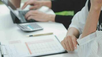 Financial analysts analyze business financial reports on a digital tablet planning investment project during a discussion at a meeting of corporate showing the results of their successful teamwork. video