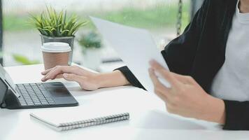 Financial analysts analyze business financial reports on a digital tablet planning investment project during a discussion at a meeting of corporate showing the results of their successful teamwork. video