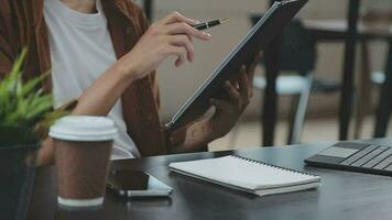 Financial analysts analyze business financial reports on a digital tablet planning investment project during a discussion at a meeting of corporate showing the results of their successful teamwork. video