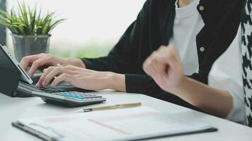Financial analysts analyze business financial reports on a digital tablet planning investment project during a discussion at a meeting of corporate showing the results of their successful teamwork. video