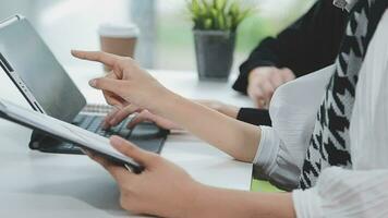 Financial analysts analyze business financial reports on a digital tablet planning investment project during a discussion at a meeting of corporate showing the results of their successful teamwork. video