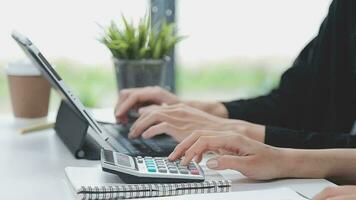 Financial analysts analyze business financial reports on a digital tablet planning investment project during a discussion at a meeting of corporate showing the results of their successful teamwork. video