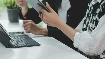 Financial analysts analyze business financial reports on a digital tablet planning investment project during a discussion at a meeting of corporate showing the results of their successful teamwork. video