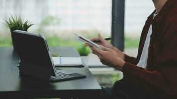 Financial analysts analyze business financial reports on a digital tablet planning investment project during a discussion at a meeting of corporate showing the results of their successful teamwork. video