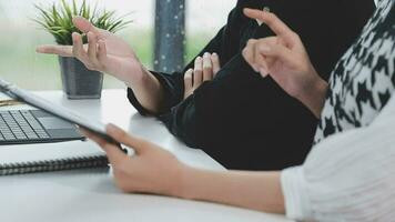 Financial analysts analyze business financial reports on a digital tablet planning investment project during a discussion at a meeting of corporate showing the results of their successful teamwork. video