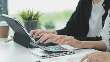 Financial analysts analyze business financial reports on a digital tablet planning investment project during a discussion at a meeting of corporate showing the results of their successful teamwork. video