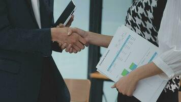 Financial analysts analyze business financial reports on a digital tablet planning investment project during a discussion at a meeting of corporate showing the results of their successful teamwork. video