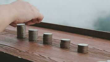 Businessman stacking coins with a graph of profit. Business successful growth video