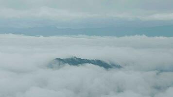 Mountain range with visible silhouettes through the morning blue fog. video