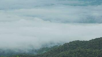 Mountain range with visible silhouettes through the morning blue fog. video