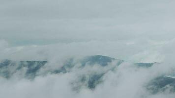 montagna gamma con visibile sagome attraverso il mattina blu nebbia. video