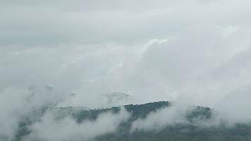 Mountain range with visible silhouettes through the morning blue fog. video