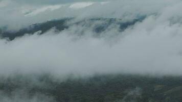 Mountain range with visible silhouettes through the morning blue fog. video