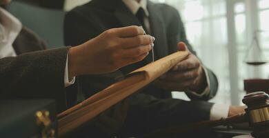 Judge gavel with Justice lawyers having team meeting at law firm background. Concepts of Law and Legal services. photo