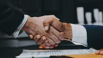 Business and lawyers discussing contract papers with brass scale on desk in office. Law, legal services, advice, justice and law concept picture with film grain effect video