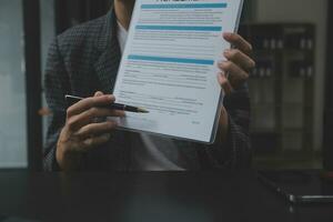 Business and lawyers discussing contract papers with brass scale on desk in office. Law, legal services, advice, justice and law concept picture with film grain effect photo