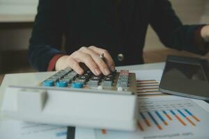 Unrecognizable businessman using calculator photo