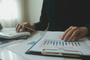 Unrecognizable businessman using calculator photo