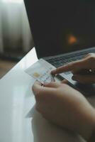 Woman hands holding and using cradit card for shopping online. photo