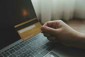 Woman hands holding and using cradit card for shopping online. photo