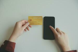 Woman hands holding and using cradit card for shopping online. photo