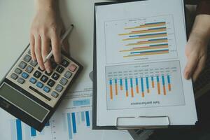 Unrecognizable businessman using calculator photo
