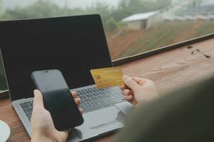 online payment, young woman holding credit card and touching on smartphone screen, copy space photo