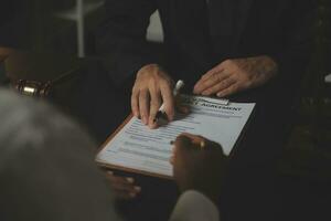 Business and lawyers discussing contract papers with brass scale on desk in office. Law, legal services, advice, justice and law concept picture with film grain effect photo