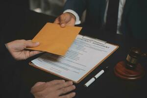 Business and lawyers discussing contract papers with brass scale on desk in office. Law, legal services, advice, justice and law concept picture with film grain effect photo