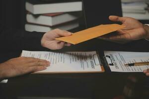 Business and lawyers discussing contract papers with brass scale on desk in office. Law, legal services, advice, justice and law concept picture with film grain effect photo