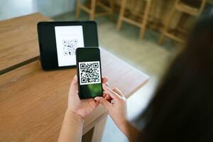 Qr code payment. Woman scanning QR code online shopping cashless technology concept. photo