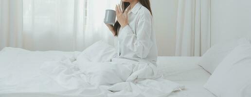 Woman stretching in bed after wake up photo