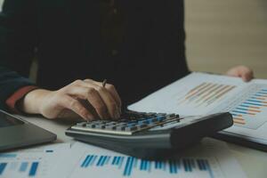 Unrecognizable businessman using calculator photo
