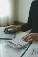 Unrecognizable businessman using calculator photo
