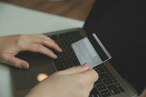 Woman hands holding and using cradit card for shopping online. photo