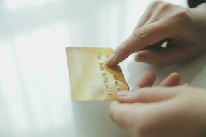 Woman hands holding and using cradit card for shopping online. photo