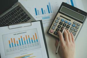 Unrecognizable businessman using calculator photo