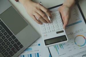 Unrecognizable businessman using calculator photo