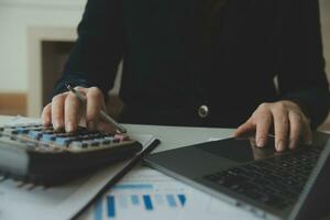 Unrecognizable businessman using calculator photo
