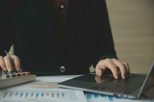 Unrecognizable businessman using calculator photo