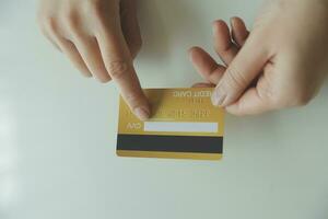 Woman hands holding and using cradit card for shopping online. photo