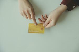 Woman hands holding and using cradit card for shopping online. photo