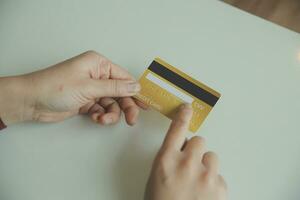 Woman hands holding and using cradit card for shopping online. photo